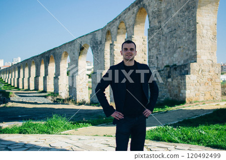 young man near the ancient Kamares Aqueduct, Larnaca, Cyprus young man near the ancient Kamares Aqueduct, Larnaca, Cyprus 120492499