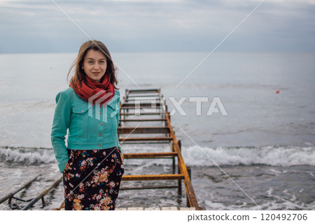 a young woman in bright clothes on an old rusty pier on the seashore, Ayia Napa, Cyprus a young woman in bright clothes on an old rusty pier on the seashore, Ayia Napa, Cyprus 120492706