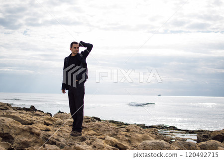 young man with a backpack on the seashore young man with a backpack on the seashore 120492715