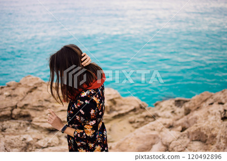 a young woman on rocky coast with turquoise water of Ayia Napa, Cyprus a young woman on rocky coast with turquoise water of Ayia Napa, Cyprus 120492896