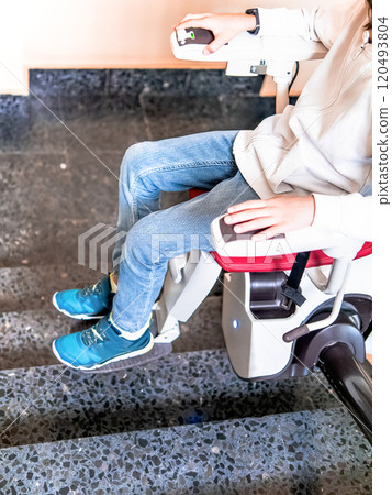 Close-Up of Child's Legs on Stairlift Close-Up of Child's Legs on Stairlift 120493804