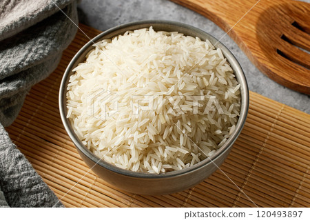 bowl of uncooked rice 120493897