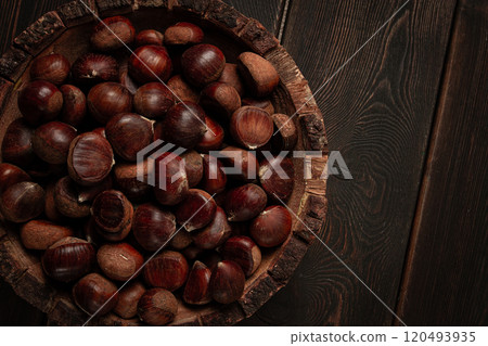 fresh chestnuts, in a wooden bowl, top view, no people, 120493935