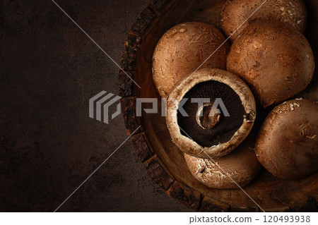 fresh Portobello mushrooms, in a wooden bowl, top view, close-up, no people, 120493938