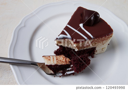 slice of cake, bird's milk, chocolate sponge cake with souffle, sweet dessert, on a white plate, close-up, horizontal, no people, 120493998