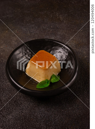 cream caramel pudding, with caramel sauce, dessert,breakfast, on a black plate, mint, no people, 120494006
