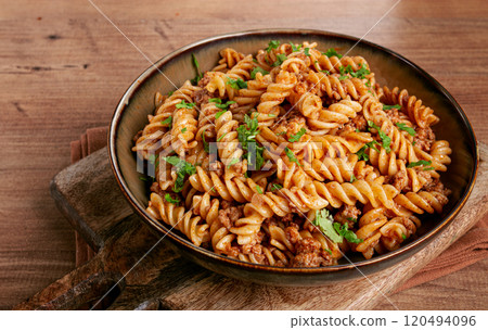 pasta in the navy, pasta with minced meat, plate on a wooden table, homemade, fusilli pasta, without people, pasta in the navy, pasta with minced meat, plate on a wooden table, homemade, fusilli pasta, without people, 120494096
