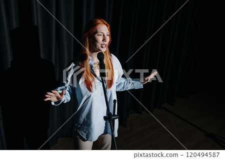 Performing on Stage with Microphone Under Spotlight Performing on Stage with Microphone Under Spotlight 120494587