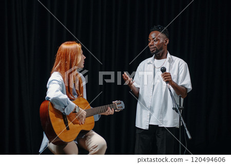 Sharing Music and Singing on Stage With Guitar 120494606