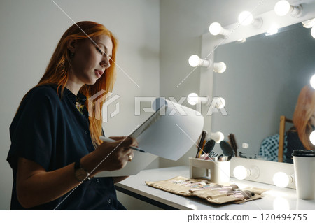 Contemplating Work While Reviewing Documents in Dressing Room Contemplating Work While Reviewing Documents in Dressing Room 120494755
