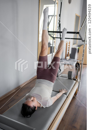 Yoga Instruction Exploring the Enhanced Partner Stretching Technique with in a Studio. Inversion pose to enhance flexibility and balance Yoga Instruction Exploring the Enhanced Partner Stretching Technique with in a Studio. Inversion pose to enhance flexibility and balance 120494839