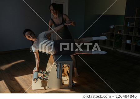 Join us for a comprehensive fitness session in our modern studio featuring Pilates training 120494840