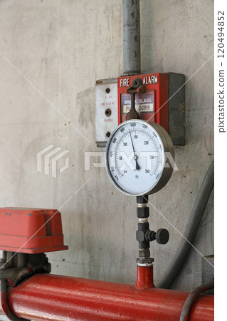 Pressure gauges or pressure manometer mounted on the pipeline and signal FIRE ALARM system, wire tubes attached on wall. Pressure gauges or pressure manometer mounted on the pipeline and signal FIRE ALARM system, wire tubes attached on wall. 120494852