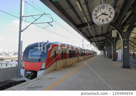 The red suburban train ready for service, Locomotive at platform inside railway station. The red suburban train ready for service, Locomotive at platform inside railway station. 120494854