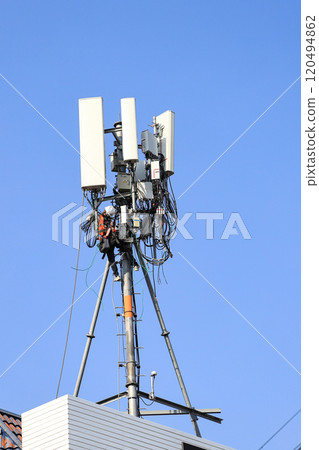 Technician maintenance Wireless Communication Antenna pole or Mobile phone mast antenna pole on top of dilapidated building. Technician maintenance Wireless Communication Antenna pole or Mobile phone mast antenna pole on top of dilapidated building. 120494862