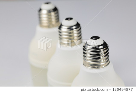 White LED bulb or light bulb with connector type e27 for energy saving with shallow focus isolated on white background. 120494877