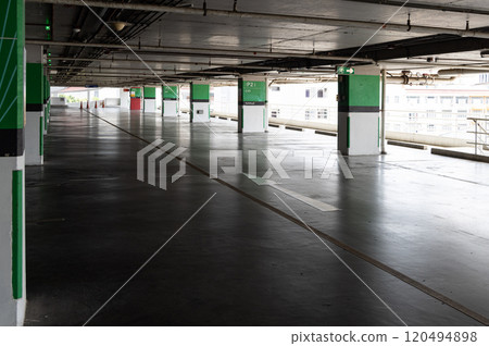 Dimly lit empty parking garage, Parking lot with empty places. Dimly lit empty parking garage, Parking lot with empty places. 120494898