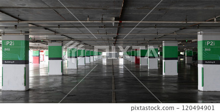 Dimly lit empty parking garage, Parking lot with empty places. 120494901