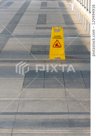 Sign showing warning of cleaning process area, Yellow sign that alerts for cleaning process, Warning symbol of Slippy floor for pedestrian. 120494916