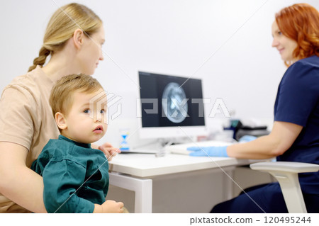 Toddler boy with his mom are at appointment with a pediatric neurologist. A mother tells an attentive doctor about her baby injury Toddler boy with his mom are at appointment with a pediatric neurologist. A mother tells an attentive doctor about her baby injury 120495244