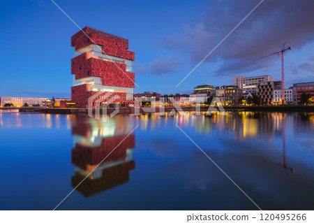 MAS museum, Antwerp, Belgium. Cityscape during sunset. Reflection on the water surface. MAS museum, Antwerp, Belgium. Cityscape during sunset. Reflection on the water surface. 120495266