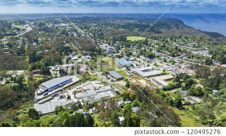 An area of industrial and DIY supplier buildings surrounded by greenery 120495276