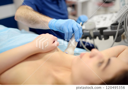 Mammologist doctor examines a woman breasts and lymph nodes using ultrasound. Mammography and ultrasound scanning are main methods of instrumental diagnosis of mammary glands. Breast cancer 120495356