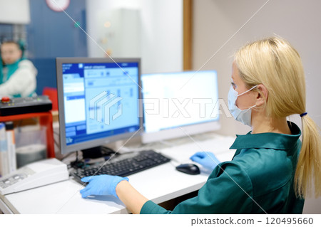 Female radiologist is going to take X ray of patient in X-ray room of modern clinic or hospital. Modern medical technology Female radiologist is going to take X ray of patient in X-ray room of modern clinic or hospital. Modern medical technology 120495660