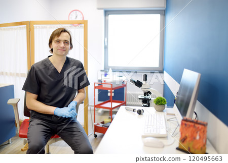 Portrait of male dermatologist in office in modern clinic. Doctor during appointment of patient at work place. Portrait of male dermatologist in office in modern clinic. Doctor during appointment of patient at work place. 120495663