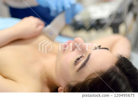 Mammologist doctor examines a woman breasts and lymph nodes using ultrasound. Mammography and ultrasound scanning are main methods of instrumental diagnosis of mammary glands. Breast cancer 120495675