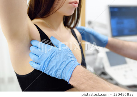 Doctor mammologist examines woman breasts and lymph nodes. Correcting the shape of the breast - lift, reduction, reconstruction, augmentation. Problems of lactation. Breast cancer. 120495952