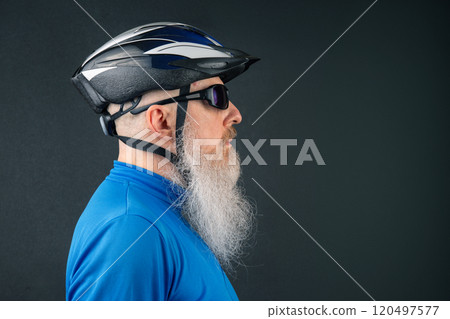 portrait of a cyclist in profile with a large white beard wearing a bicycle helmet portrait of a cyclist in profile with a large white beard wearing a bicycle helmet 120497577