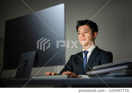 A businessman who works on a personal computer A businessman who works on a personal computer 120497778
