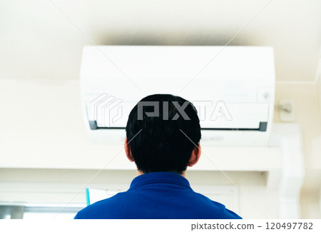 Men checking the air conditioner Men checking the air conditioner 120497782