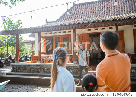 rear view grandfather waving hand greeting rear view grandfather waving hand greeting 120498642