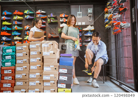 male customer try on athletic shoes 120498849
