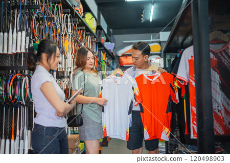 asian couple customer choosing sport jersey 120498903