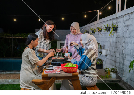 Women Delight in a Cozy Evening Filled with Fun Games, Laughter, and Tasty Snacks 120499046