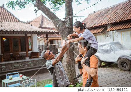 asian man carrying daughter playing with grandfather asian man carrying daughter playing with grandfather 120499121
