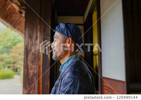 A man relaxing on the veranda of a Japanese house A man relaxing on the veranda of a Japanese house 120499144