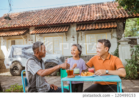 happy kid having meal with grandpa and dad 120499153