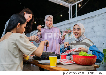 Were enjoying a fun outdoor gathering with friends and delicious food 120499365
