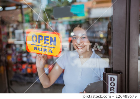 asian saleswoman holding open sign start operating business 120499579