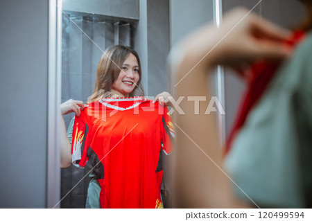 female customer trying on sport jersey female customer trying on sport jersey 120499594
