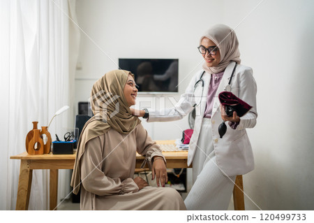 Compassionate Female Doctor Attending to Patient in Modern Clinic Setting 120499733