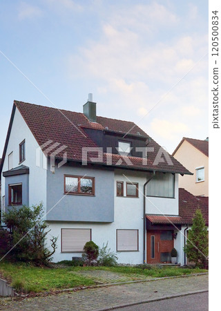 Charming House Beautifully Surrounded by Lush Greenery During the Lovely Autumn Season 120500834