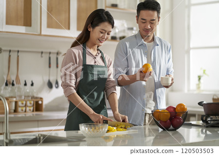 young asian couple talking chatting in kitchen young asian couple talking chatting in kitchen 120503503