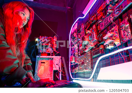 Asian woman wearing a black jacket hacking programming system check hacking hardware circuit in dark office, Cyber security agency developing, Computer electronics and technique Asian woman wearing a black jacket hacking programming system check hacking hardware circuit in dark office, Cyber security agency developing, Computer electronics and technique 120504703