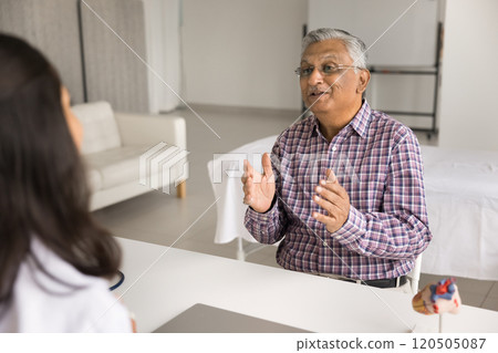 Older man, hospital patient describe symptoms during visit in clinic 120505087