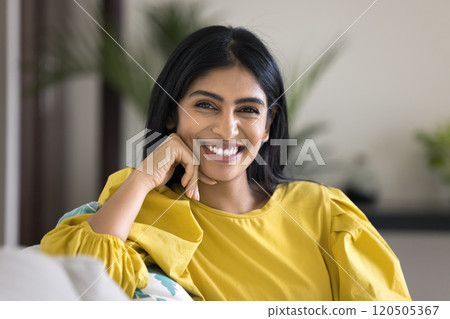 Happy beautiful young Indian woman looking at camera 120505367